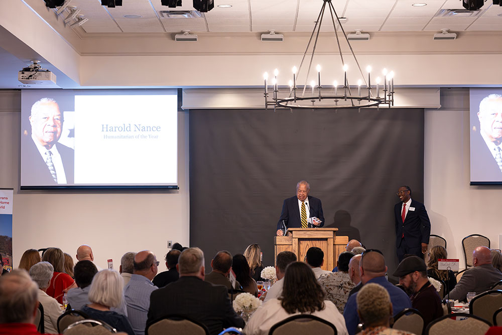 Harold Nance Humanitarian of the Year speaking at podium at the Mid-West Tennessee Heroes Luncheon..