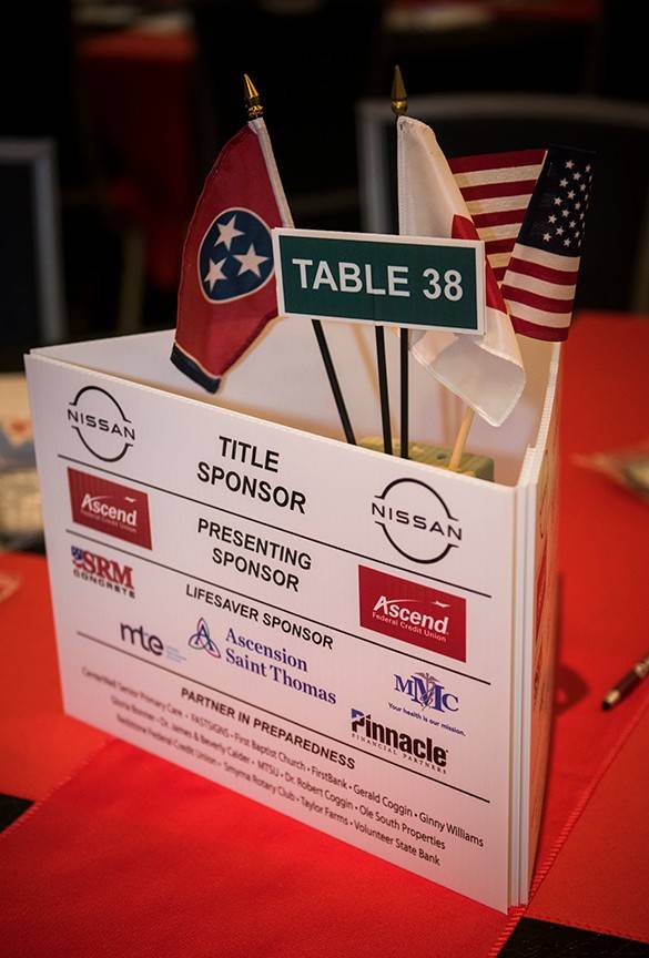 Table 38 setting with american flag and tennessee state flag with title sponsors