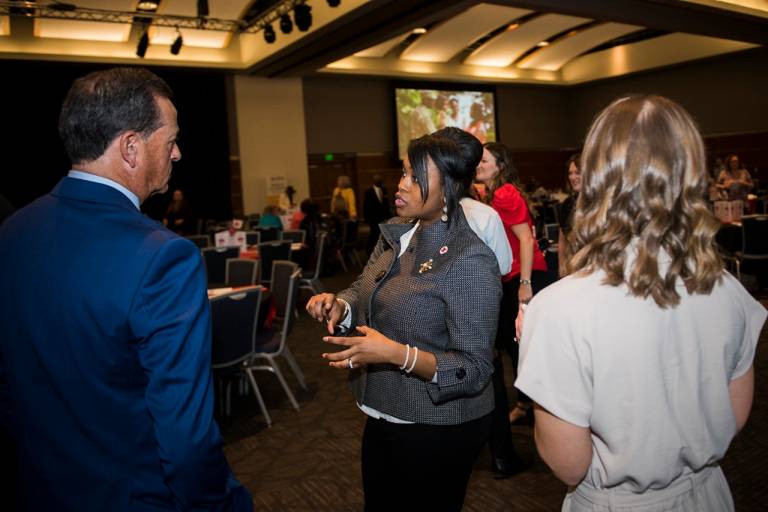 group of people talking at an event