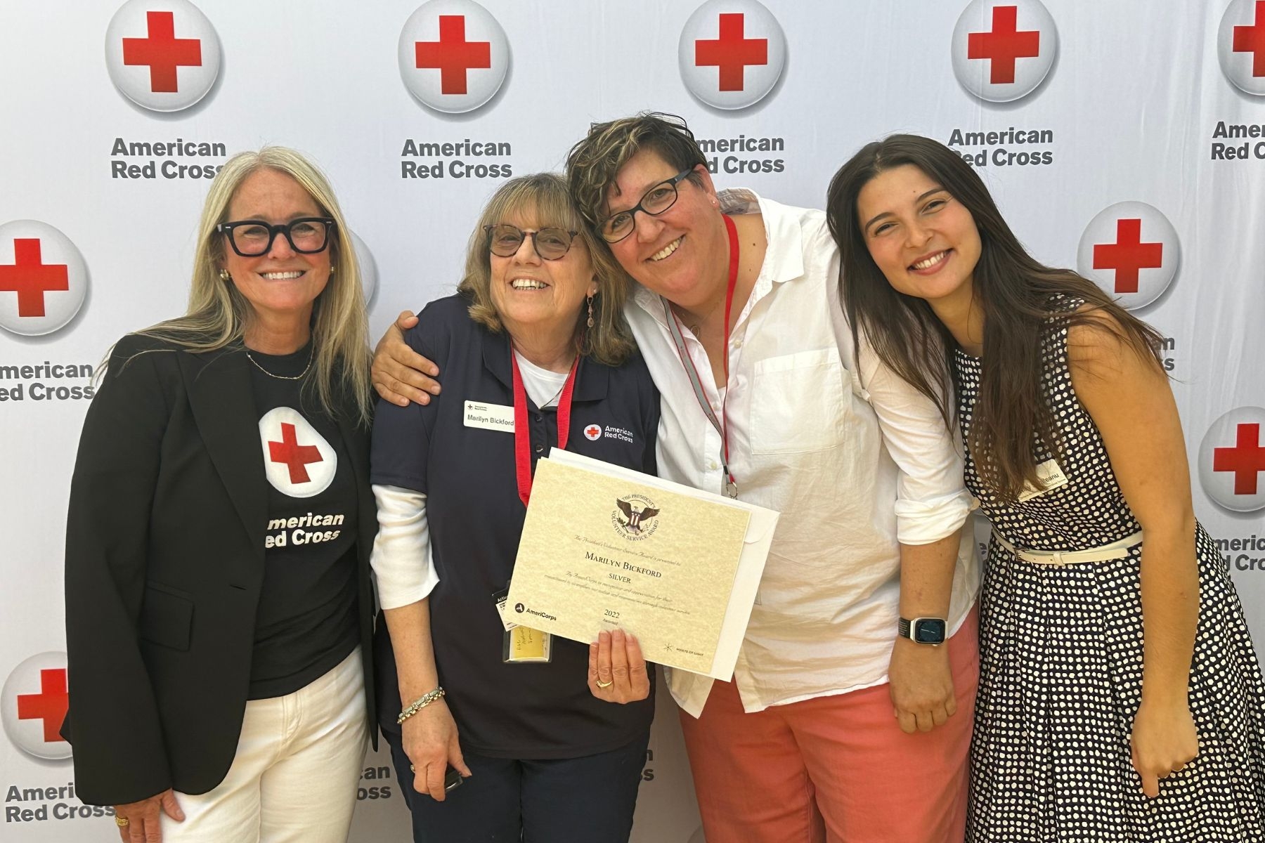 group of women holding reward certificate