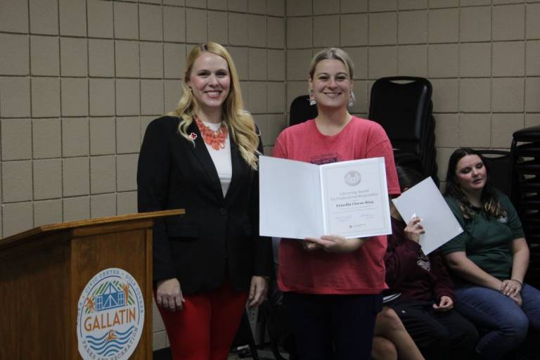 Two women stand with lifesaving award
