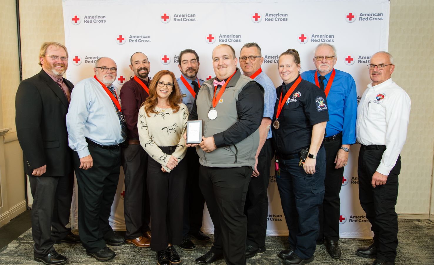 A group of people holding awards posing for a group picture