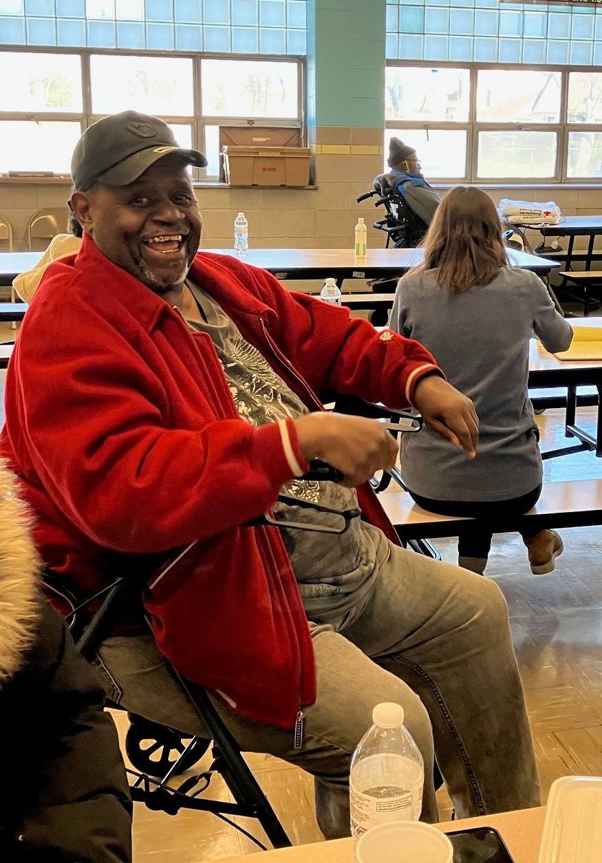 Man smiles while in Red Cross shelter