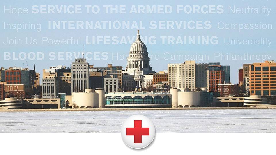 a city skyline with the Red Cross logo at the battom.