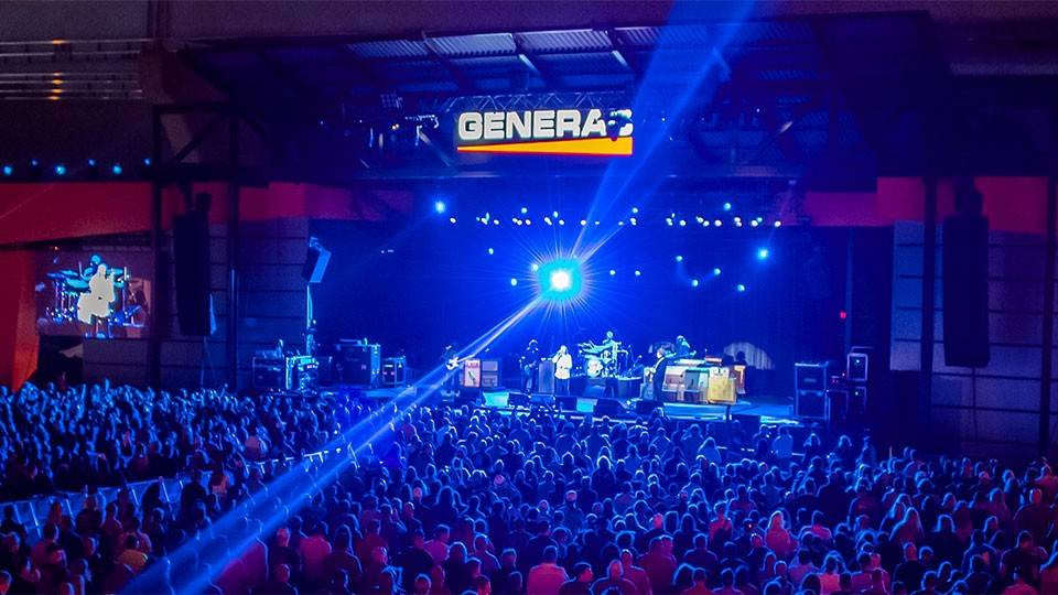 Generac Power Stage at night with large crowd and band playing