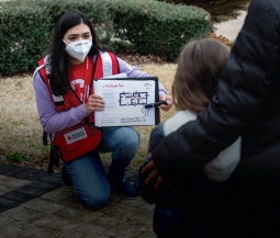 red cross volunteer helps install smoke alarms
