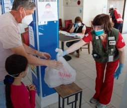 Woman and baby on cots in a Red Cross shelter