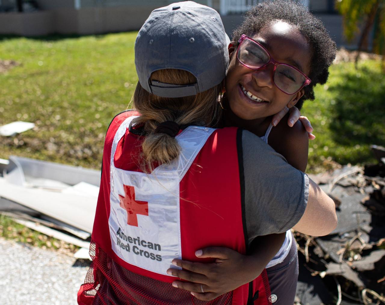 October 7, 2022. Punta Gorda, Florida.Red Cross disaster relief worker Lynette Nyman gets a hug from darling Ava who evacuated to her grandmother’s home to be safe from Hurricane Ian. Photo by Marko Kokic/American Red Cross