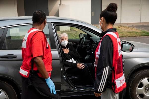 September 15, 2020. Salem, Oregon.
Leslie Sierra and Michael Watkins of the American Red Cross say goodbye to Juanita Ann Hamann as she leaves this Red Cross shelter. Juanita is moving to a hotel shelter also run by the Red Cross, in Salem, OR on Tuesday, September 15, 2020. 
Photo by Scott Dalton/American Red Cross