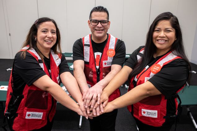 Red Cross volunteers smile while they pose with 