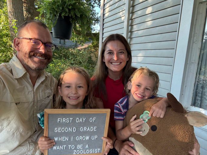 Cory poses with his wife and two children