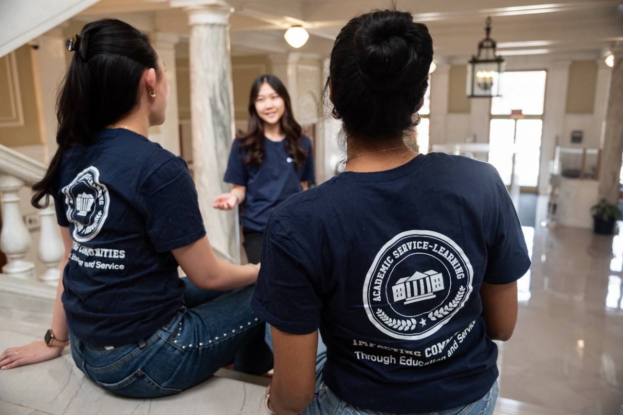 February 21, 2026. Washington, DC.National Youth Council Meeting Stock Photography 2026.Youth volunteers wearing Academic Service_Learning shirts chatting on the staircase.Photo illustration by Jason Colston/American Red CrossPlease note that this is a staged photo and shouldn't be conveyed as a real event.