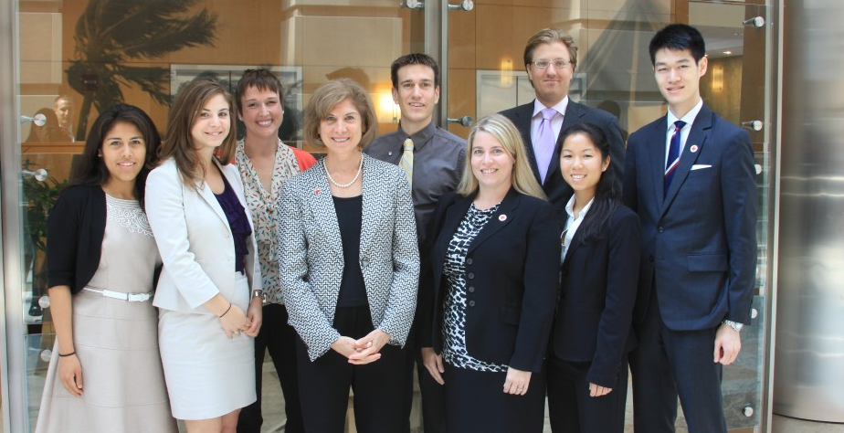 Red Cross Youth young professionals standing next to Gail McGovern, CEO of the American Red Cross.