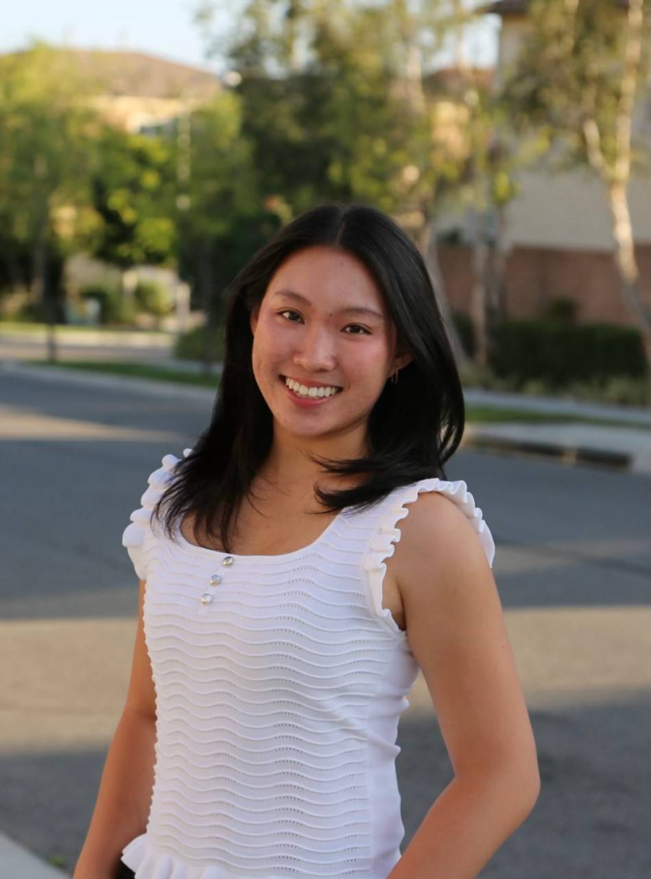 Ashley Guo, a young woman wearing white blouse, with dark brown hair. 