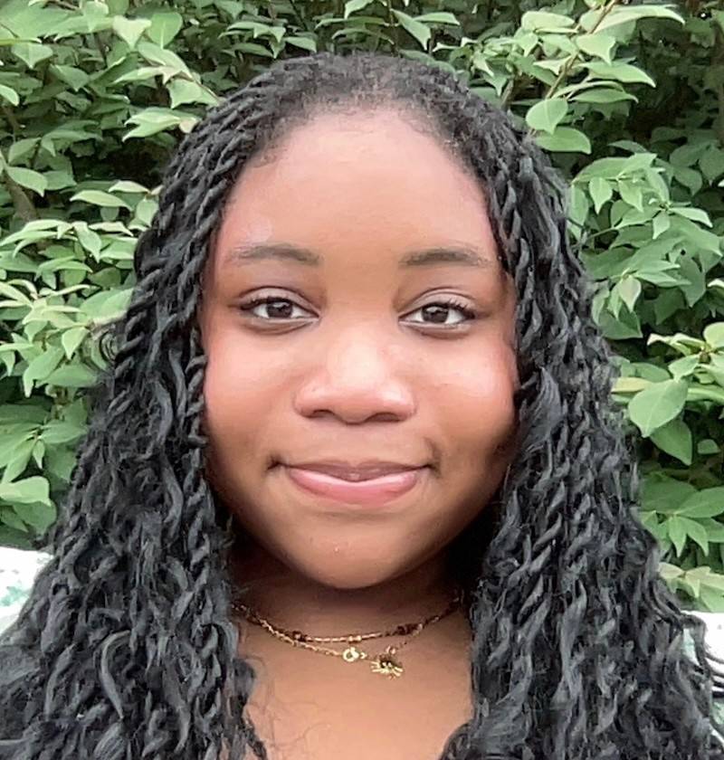 Emilia Sylla, a young woman with black hair. 