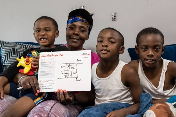 A family complete their home fire escape plan