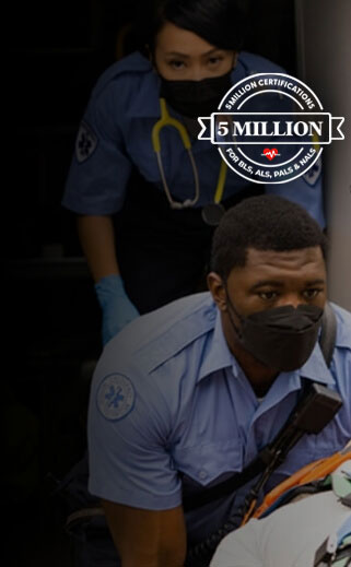 First responders transporting a patient on a wheeled stretcher.