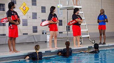 Red Cross lifeguards at aquatics facility.