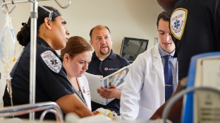 Image of healthcare professionals taking a hands-on healthcare provider training course.