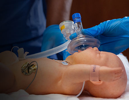 Demonstration of neonatal advanced life support on infant manikin.