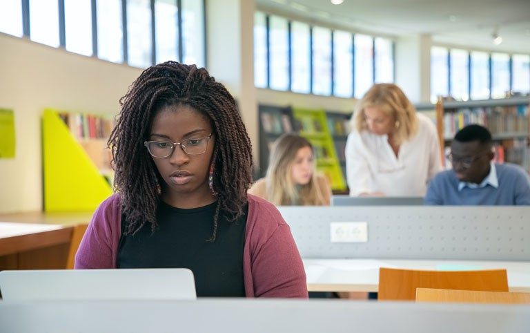 A young woman uses a laptop computer