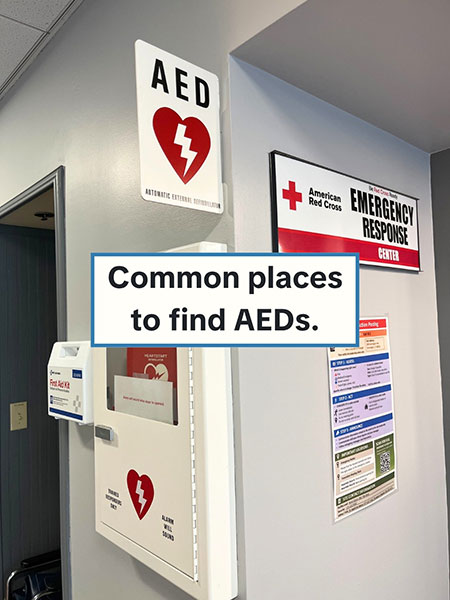 A medical office with signage for an AED with an AED and first aid kit on the wall with text 'Common places to find AEDs'.