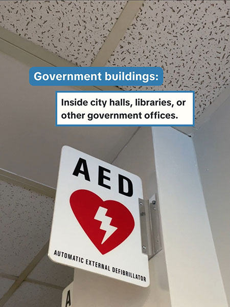 An AED wall sign with text 'Government buildings: Inside city halls, libraries or other government offices'.