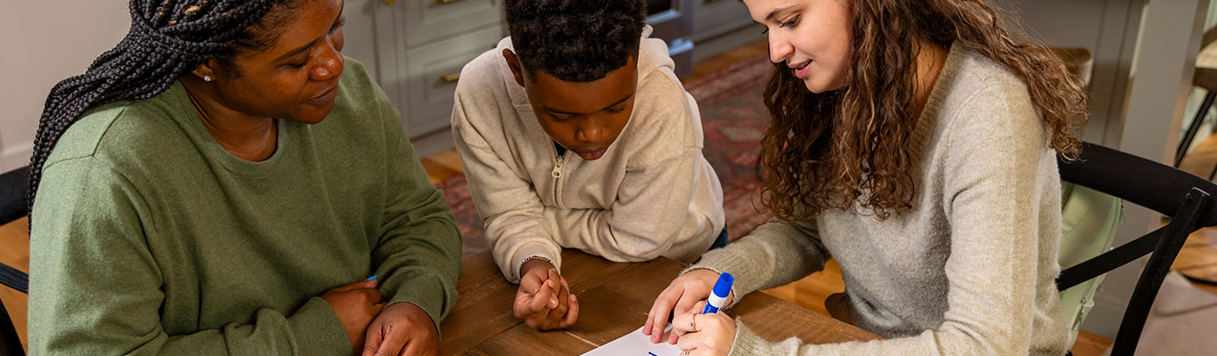 Babysitter discussing plans with a parent and child.