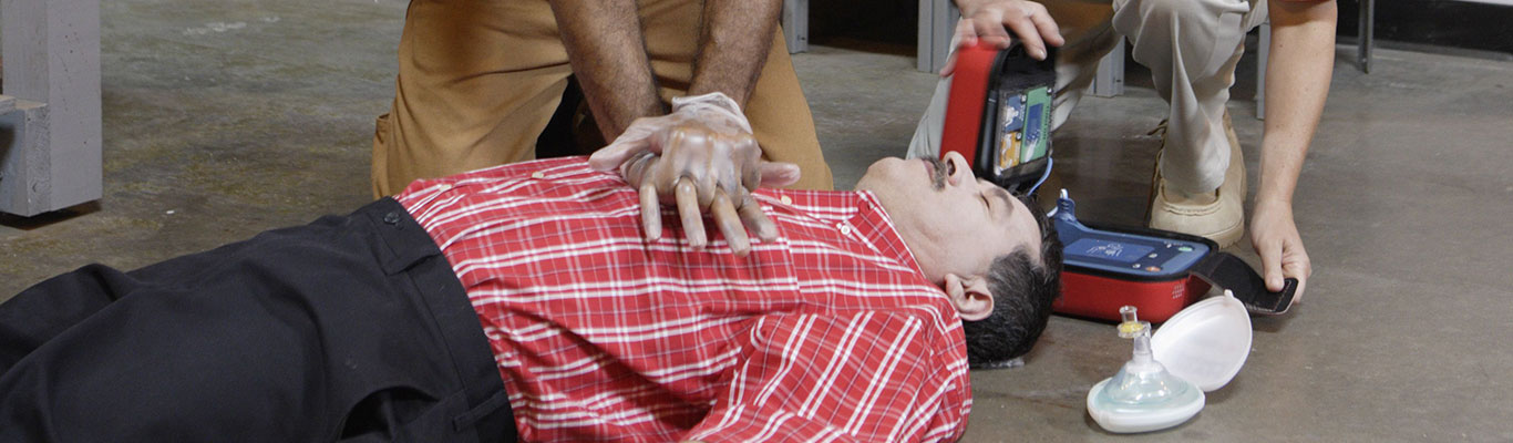 Employees performing CPR on a coworker.