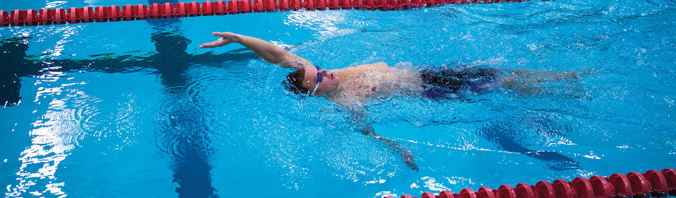 Man swimming in pool after eating.