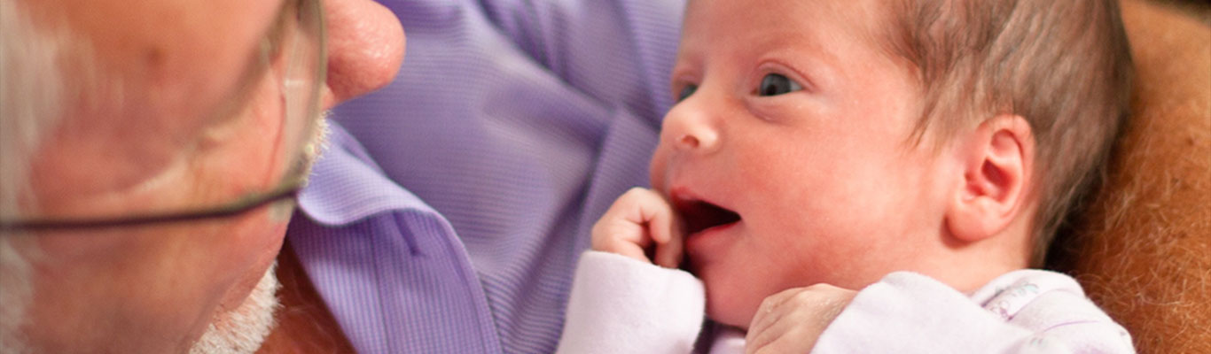 Grandfather holding infant.