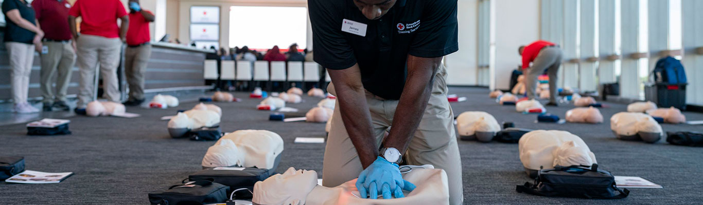 American Red Cross CPR instructor, James Eliassaint, demonstrates CPR at the Jacksonville Jaguars stadium.