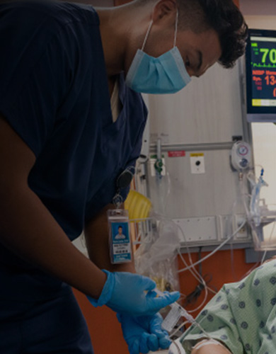Procedural sedation being performed by a male in a healthcare facility.