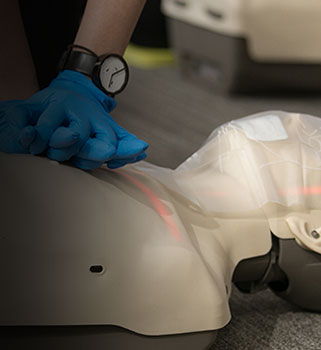 Student practicing on a CPR Manikin.