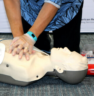 individual performing CPR on a CPR manikin