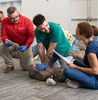 Employees and instructors participating in First Aid, CPR, and AED safety training from the American Red Cross.
