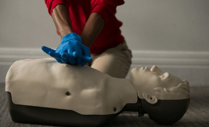individual performing CPR on a CPR manikin.