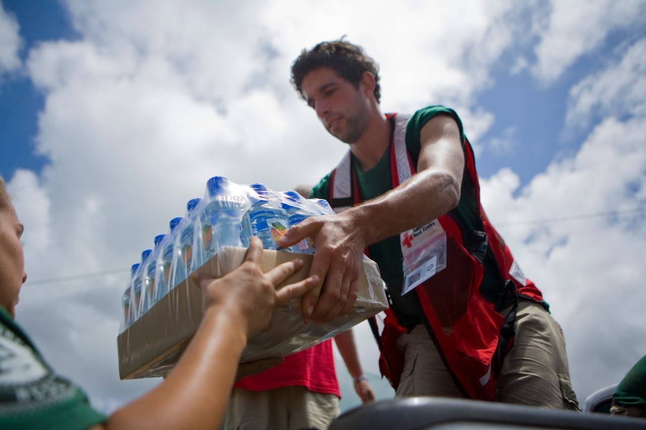 Amy Schlegel and Jeff Isaacson stack water bottles for distribution in American Samoa., Heat Safety