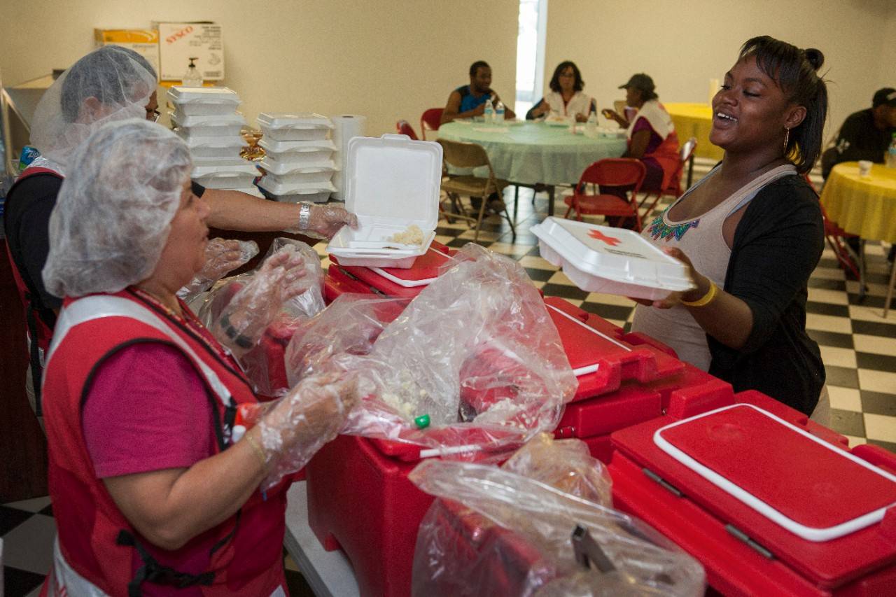 March 24, 2016.  Texas.

Michaela Issac, 19, gets a hot meal at the Orange Texas shelter.  “I love the volunteers here, I’m so thankful to have warm food.”
Red Cross workers, Santana and Idalia, feed the shelter clients in Orange Texas. All of the shelter residents know they by name, and look forward to seeing them from lunch and dinner!
Photo by Danuta Otfinowski/American Red Cross, Texas Floods 2016