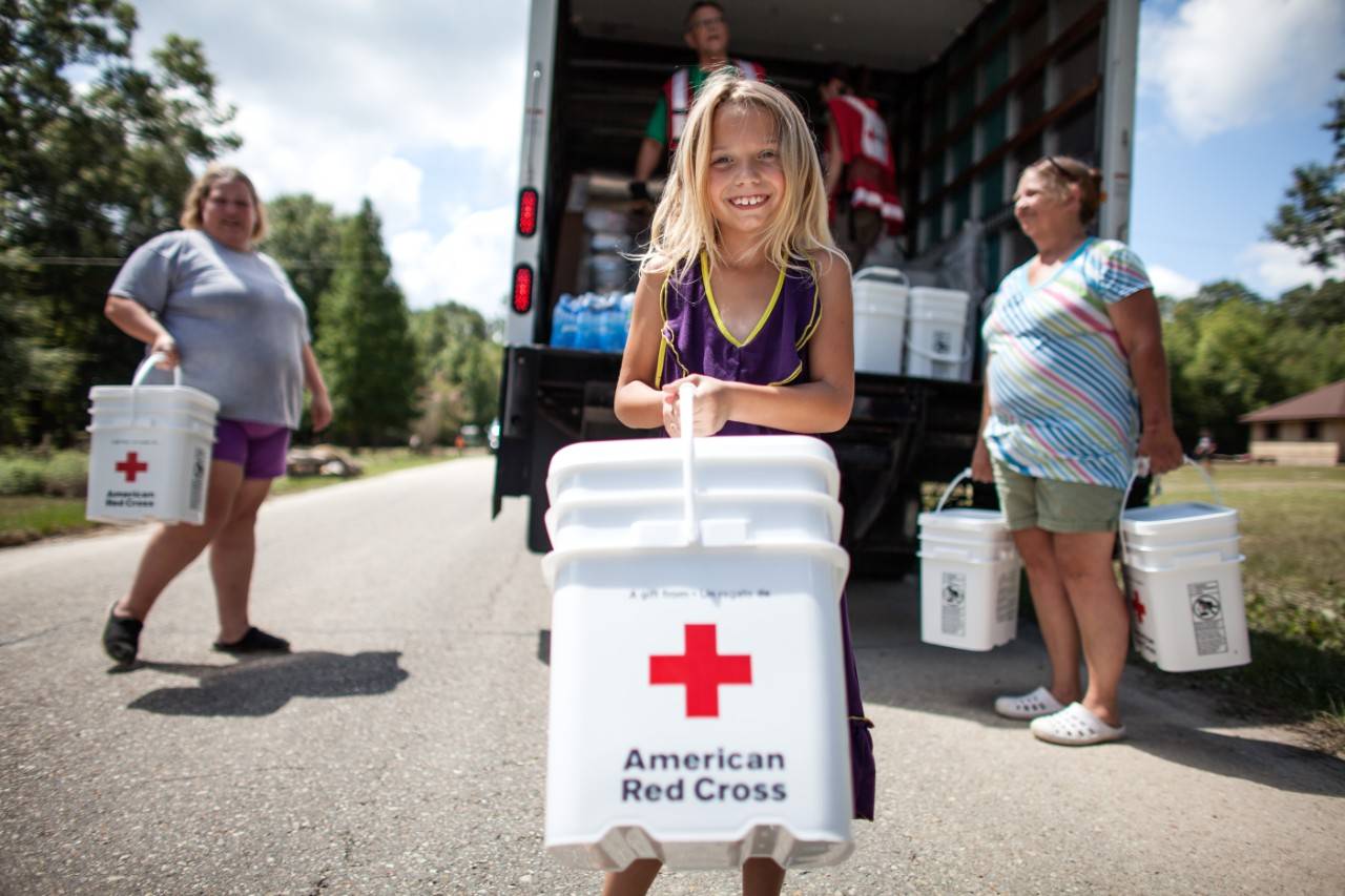 August 19, 2016. Denham Springs, Louisiana.Destiny, 8, helped carry a Red Cross clean-up kit to her home. (Her mom Hope and Aunt Linda are in the background).Photo by: Marko Kokic/American Red Cross, Year End collection for slide show