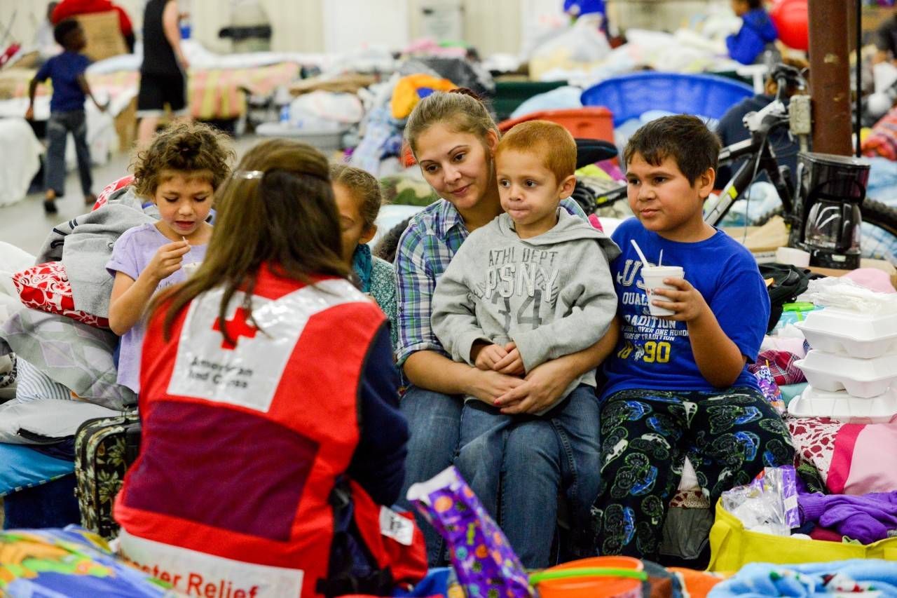 October 25, 2016. Lumberton, North Carolina. Lumberton resident Sierra and her family have spent the last week and a half sleeping on cots pushed together to form one giant bed at the Red Cross shelter. “My two older ones, Mackenzie and Jacobie, have enjoyed the time playing with all of the other kids including their cousins staying here too, but my little one is clinging close to his mama,” says Sierra. Little Christian is celebrating his 5th birthday in just a few days and will most likely be celebrating in the shelter since the family’s home was flooded and now needs completely gutted. Despite that Sierra plans to celebrate his birthday in style and no doubt the Red Cross volunteers will help make the day special.  Photo by Daniel Cima for the American Red Cross  , Bring Hope and Help this Holiday