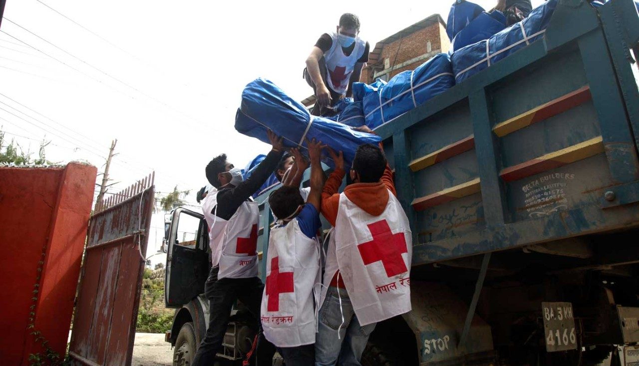 Workers unload supplies from truck