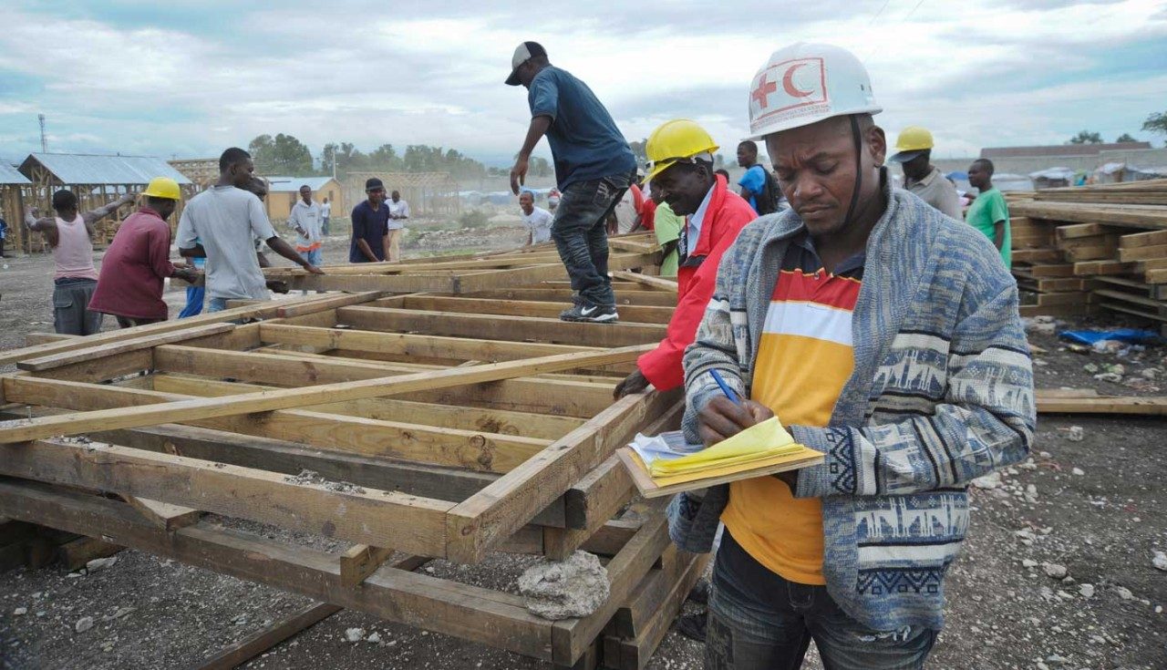 Workers in Haiti build temporary shelters