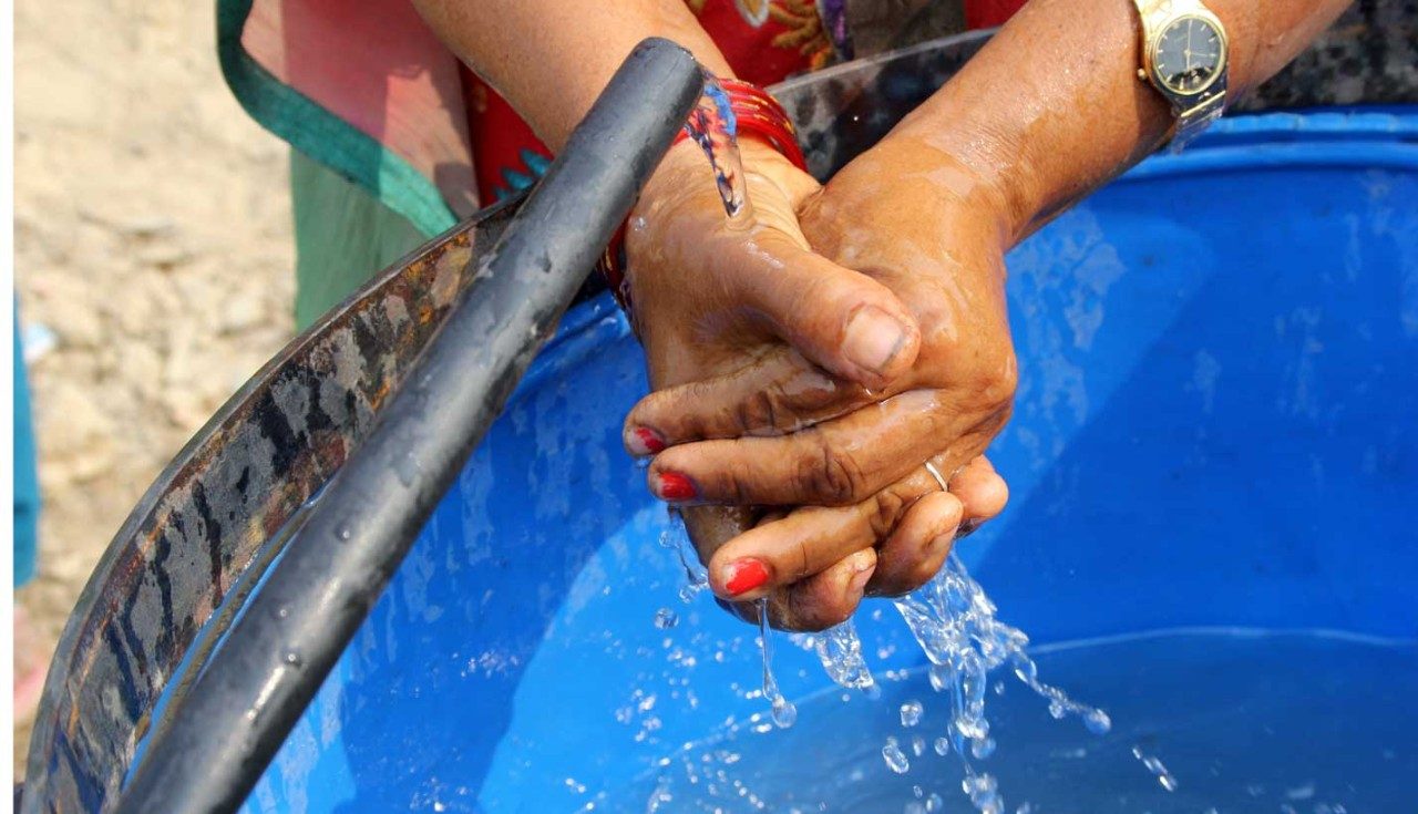 Woman washes her hands