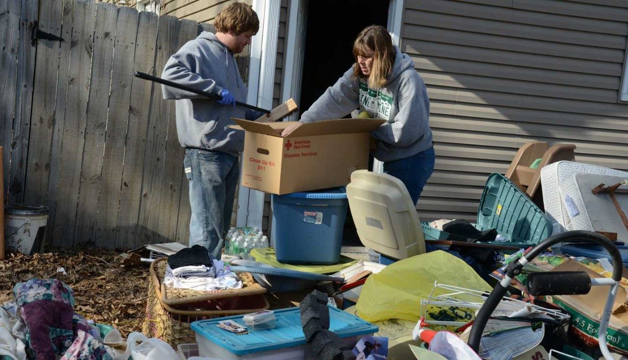 Mother and son cleaning up their yard