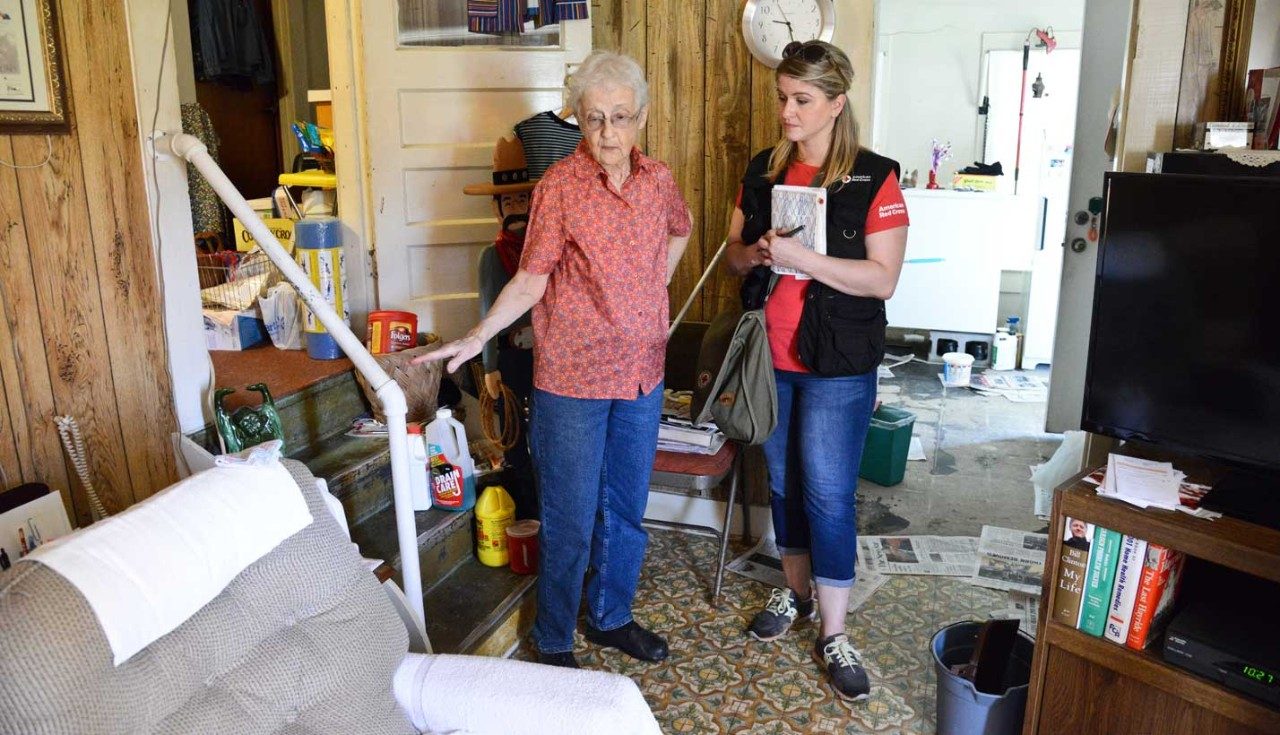 Red Cross volunteer speaking with older woman