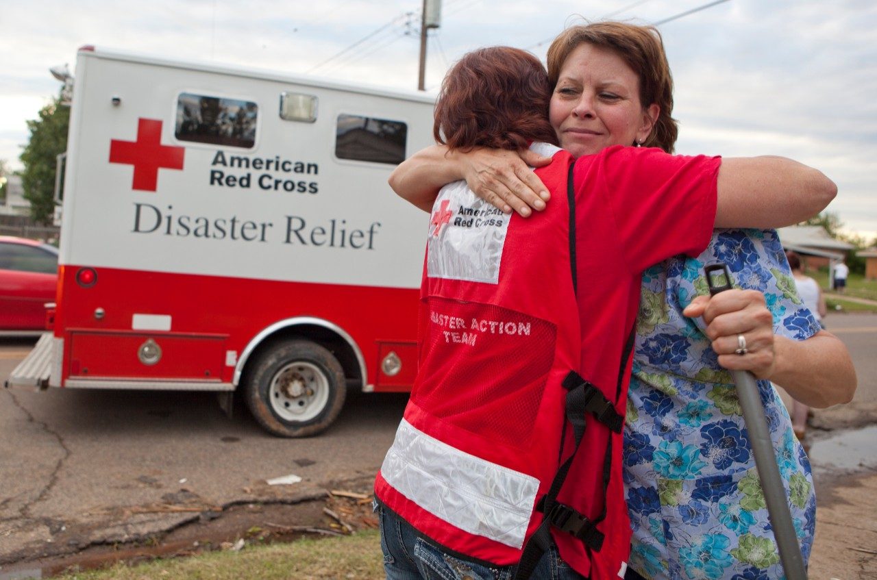 Red Cross volunteer Angela Clemins hugs Moore resident Donna Giedrocz.