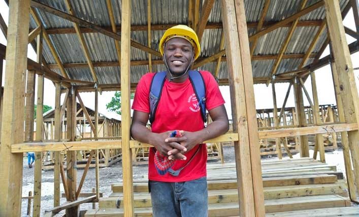 Man helps build shelter in Haiti