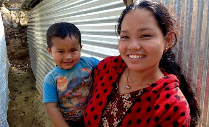 Mother in Nepal holds son