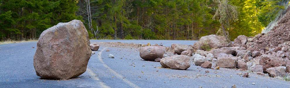 Boulder in road after landslide